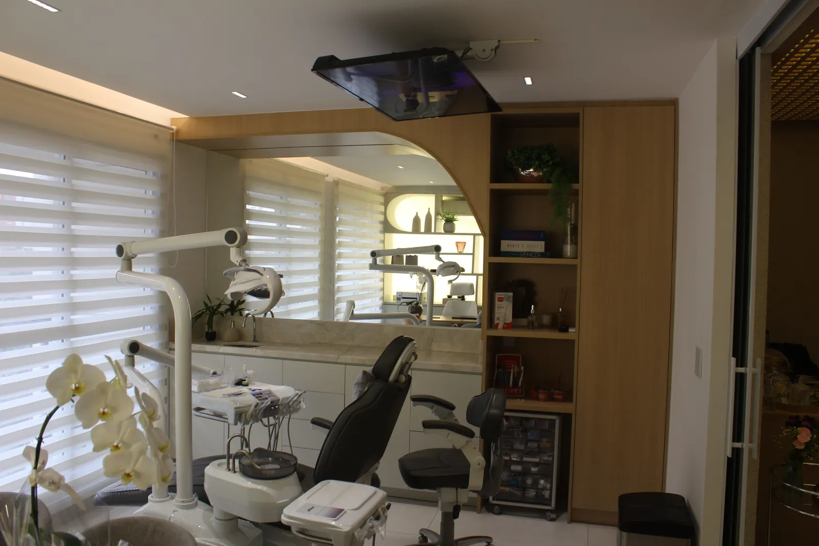 Sala clínica com cadeira odontológica, painel em arco e armário planejado, marcenaria para consultório odontológico LaArc